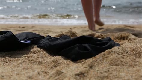 taking off bikinis|Slender young woman takes off her bikini and goes to swim in the .